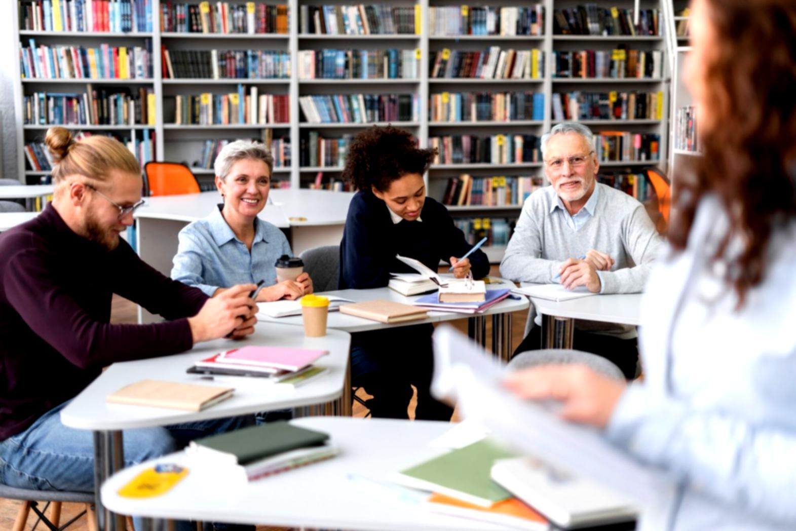 Students analyzing financial reports and market trends in classroom setting